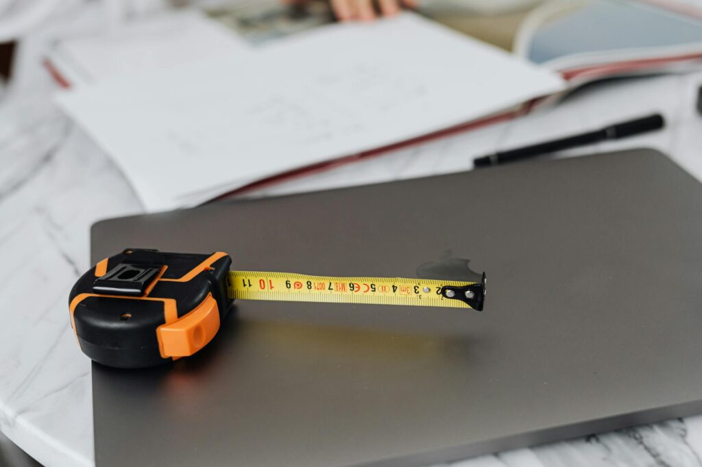 A tidy desk with plant tags, a calendar, and houseplant care notes